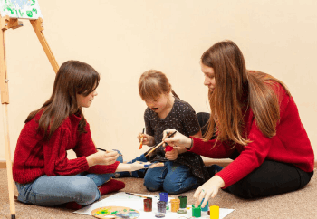 service-11 Girl with down syndrome painting with colors