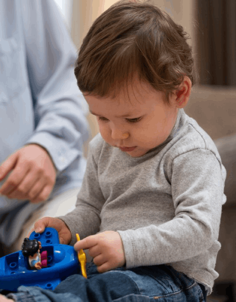 High angle cute kid playing with toy